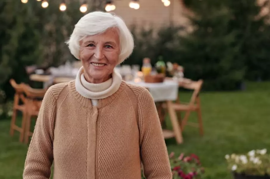 A smiling woman in front of a table